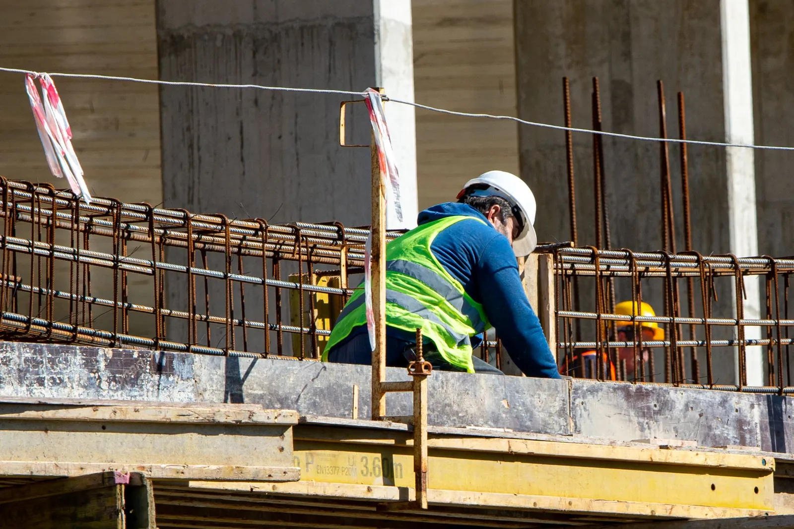 Construction worker in safety gear working on a job site